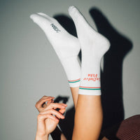 White socks with brand logos on a gray background